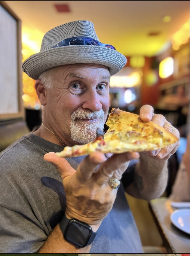 Bobby with a slice of his pizza